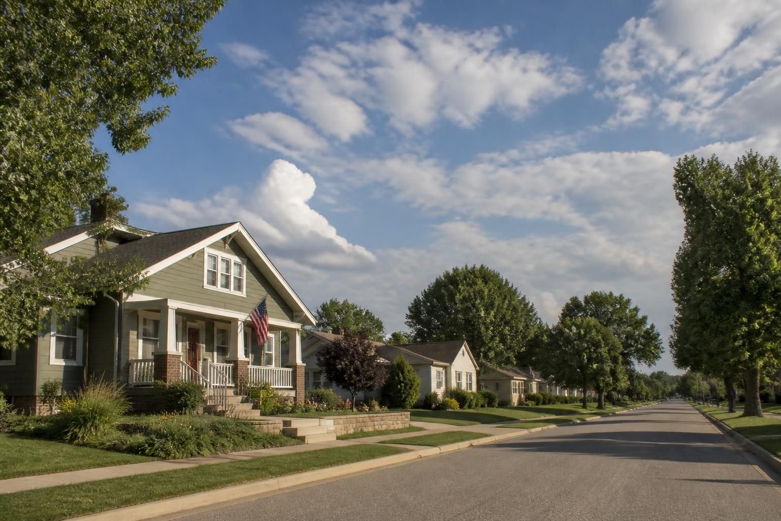 Quiet Maize neighborhood street under open Kansas sky.